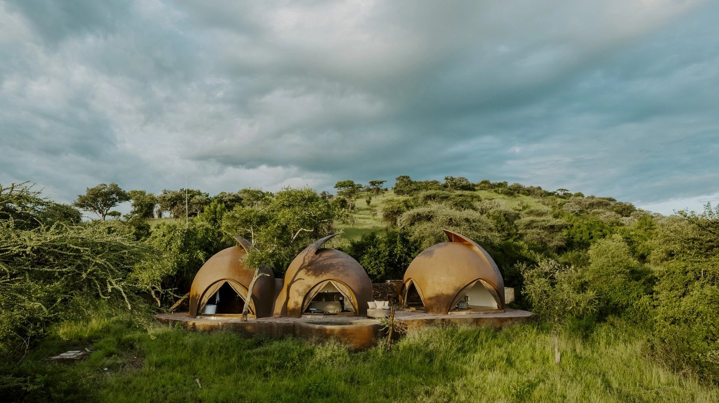 Three dome-shaped guest tents set among green bushland at Asanja Ruaha