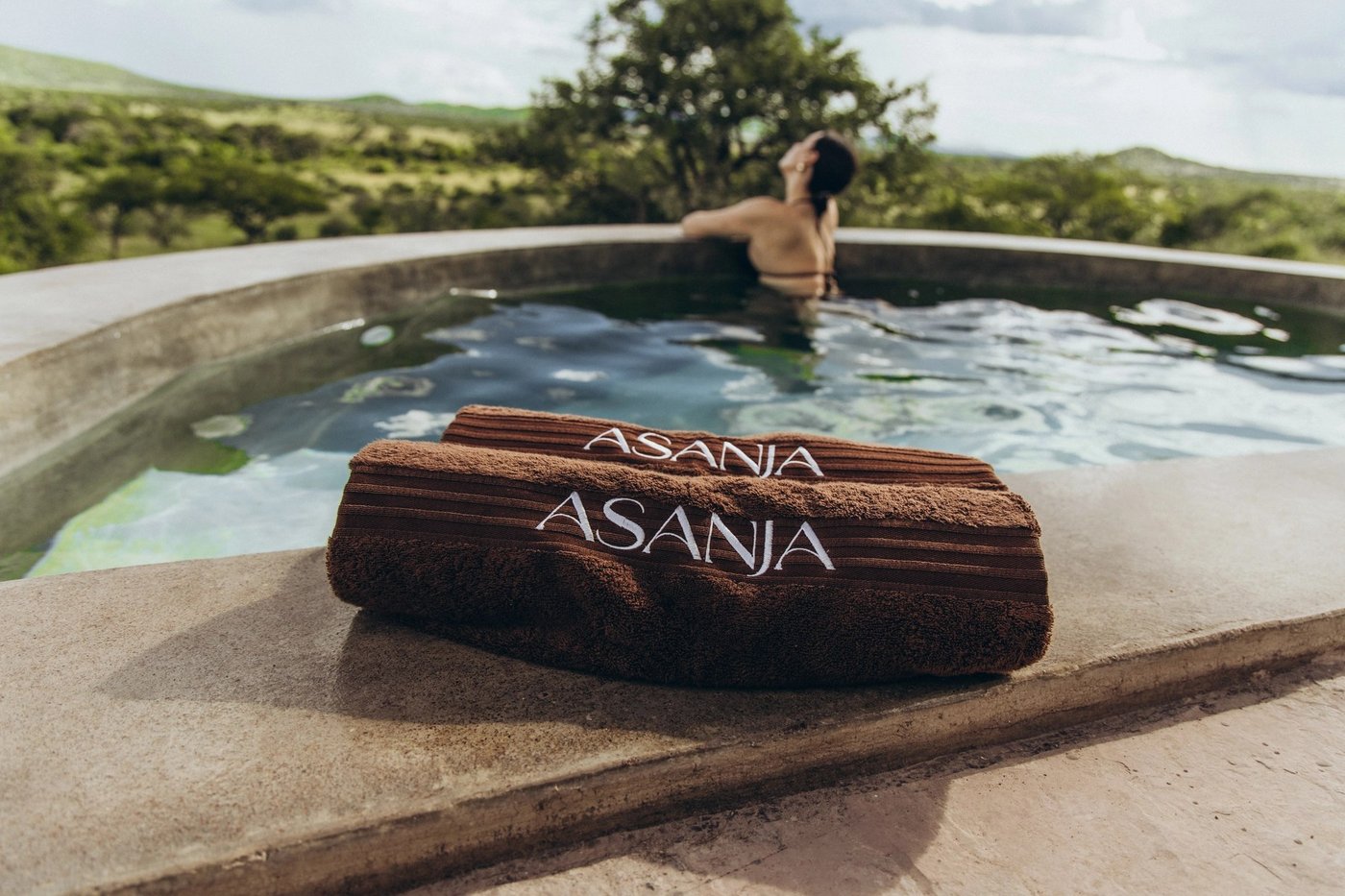 Private plunge pool overlooking green hills beyond the suite at Asanja Ruaha