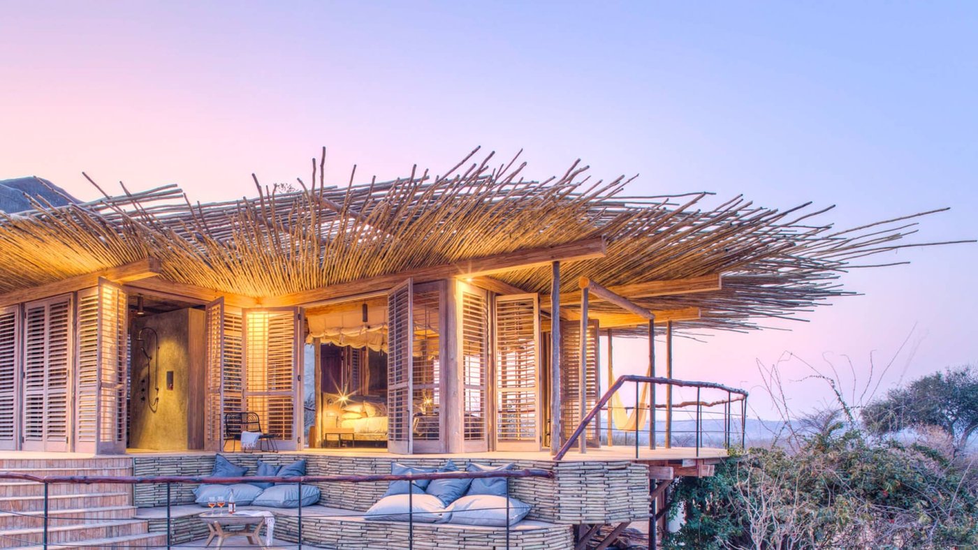Open-sided lodge perched among granite boulders at sunset at Jabali Ridge in Ruaha