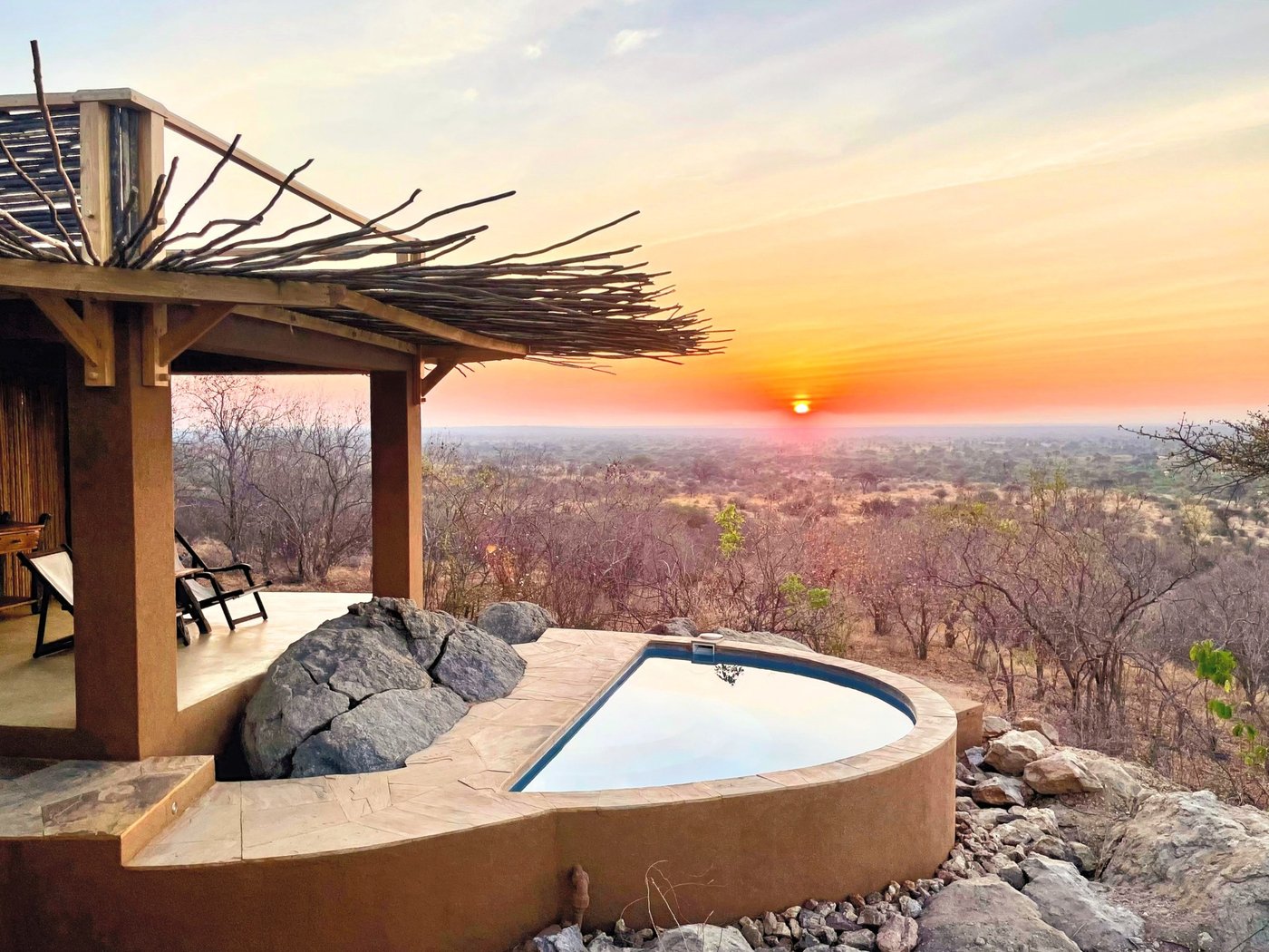 Plunge pool on a paved deck overlooking the bush at sunset at Kichaka Expeditions in Ruaha.