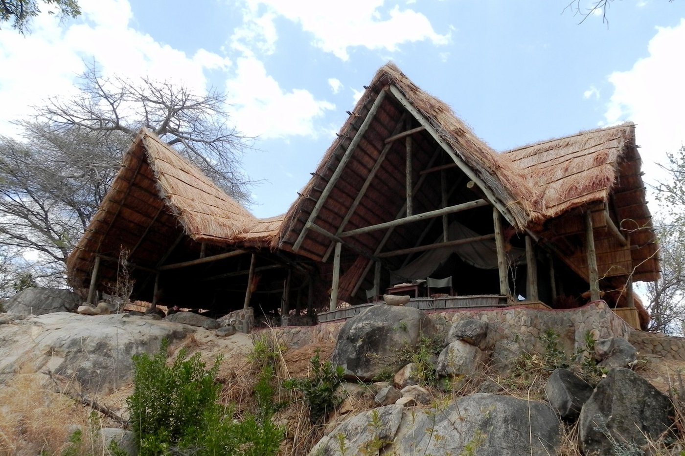 Thatched banda built into granite boulders on the Mwagusi river at Mwagusi Safari Camp in Ruaha