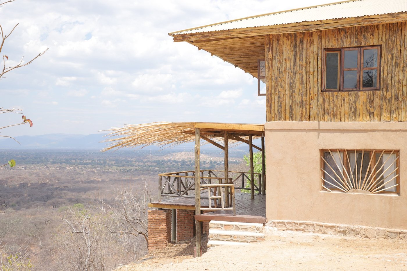 Modern cantilevered guest room with a wraparound deck overlooking the plains at Ruaha Hilltop Lodge
