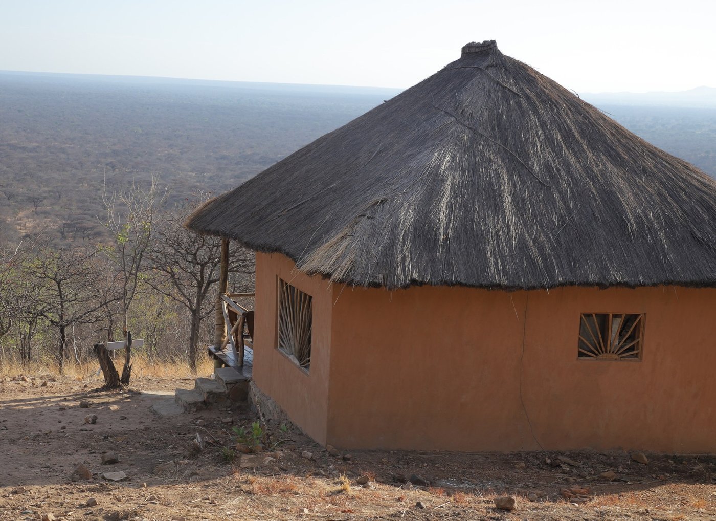 Round thatched cottage with sunburst windows overlooks the plains at Ruaha Hilltop Lodge